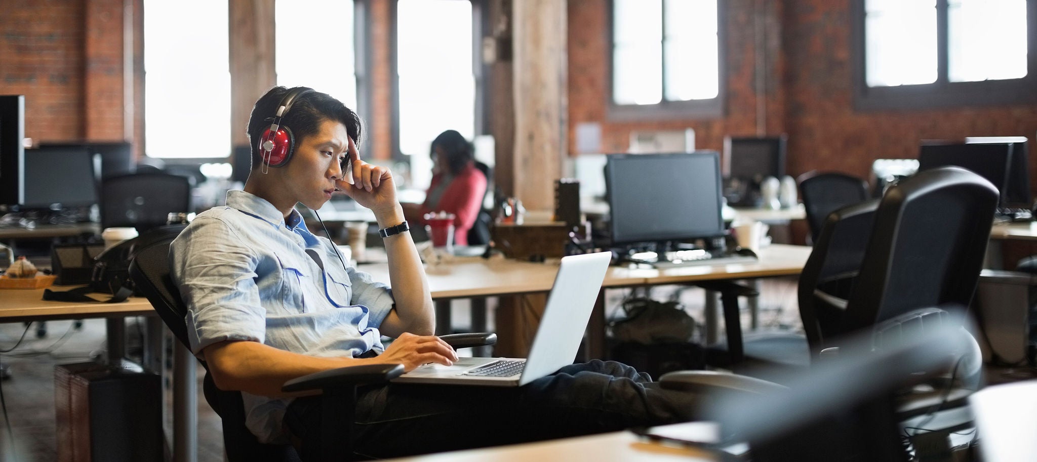 Man on a laptop researching information on cyber security