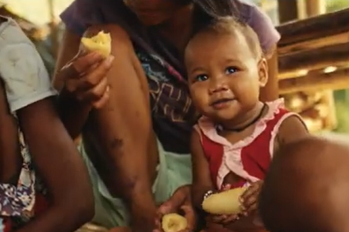 A child being held by her mother. 