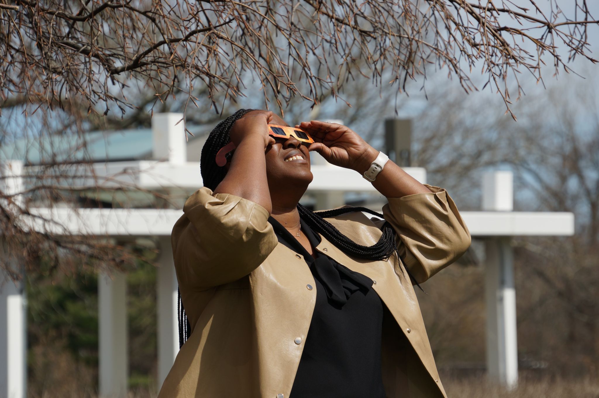 A woman wears glasses to protect her eyes during the eclipse in North America. 