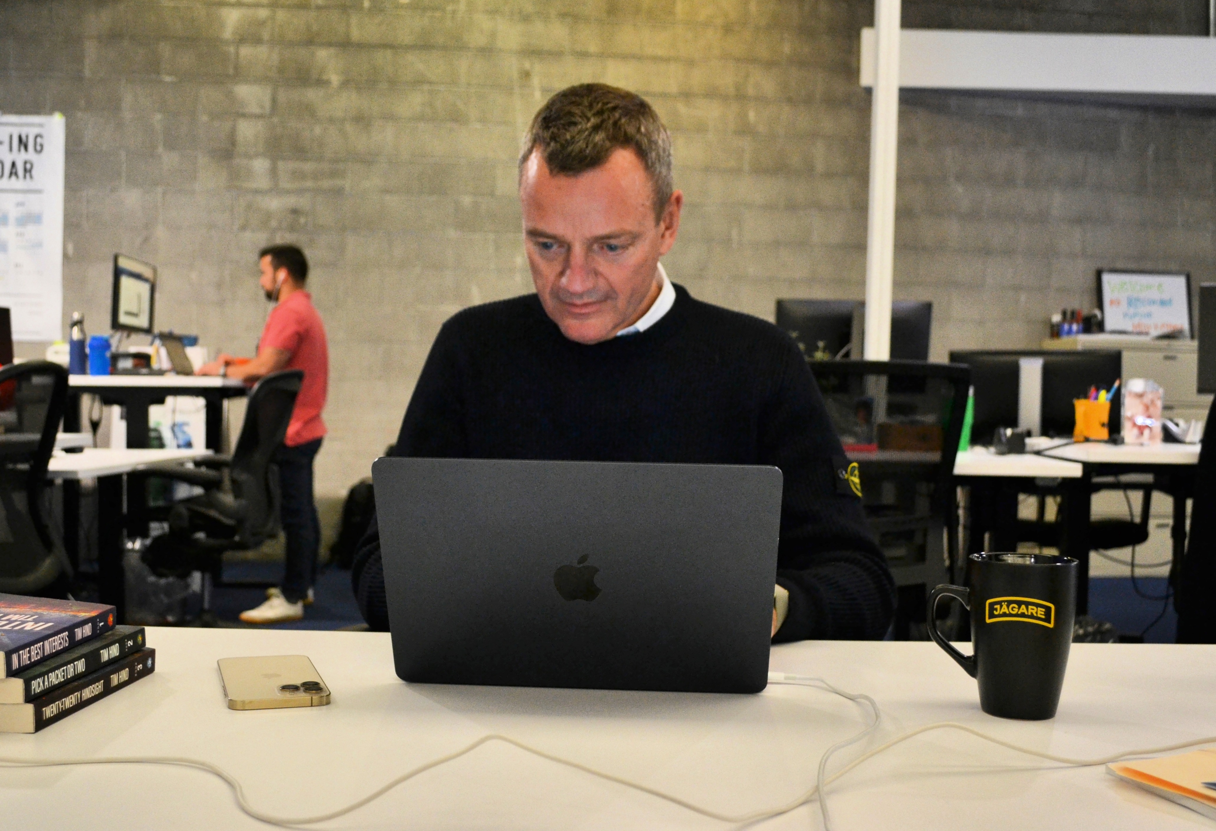 Christopher Ahlberg stands at a laptop in the Recorded Future office.