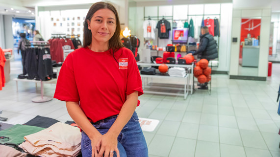 Chelsee Pettit perches on a display in her department store, Aaniin. 