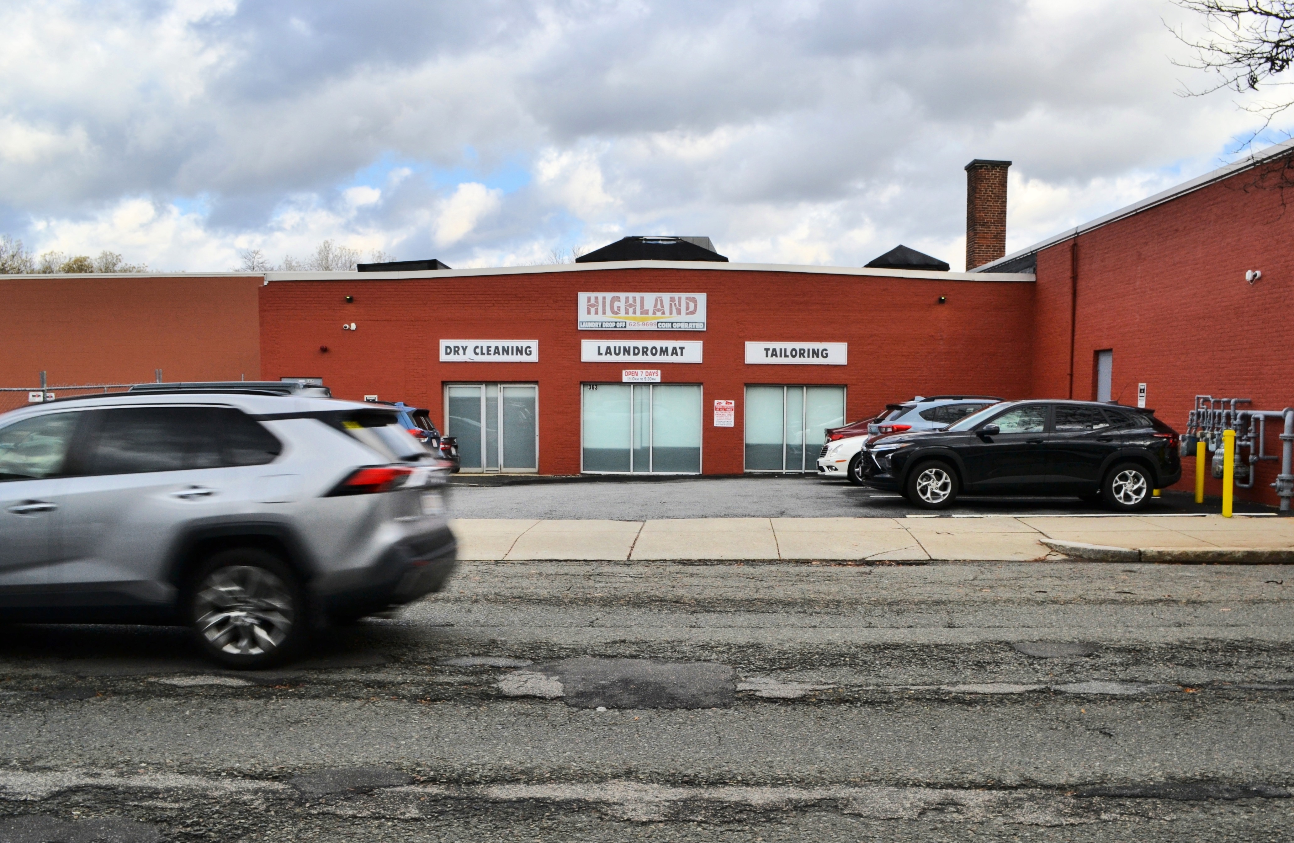 The facade of the Recorded Future building with signs for the laundromat that used to occupy the space. 