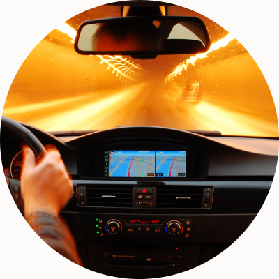 A person drives a car through a tunnel with a dashboard-embedded GPS system.