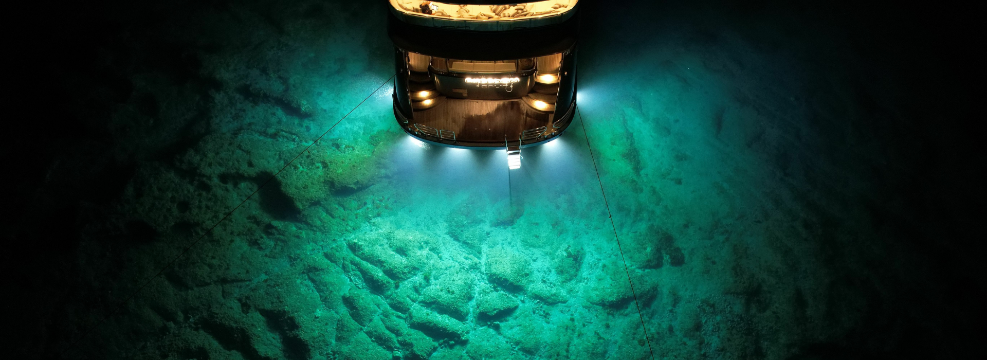 High-powered lamp illuminating a deep underwater exploration scene